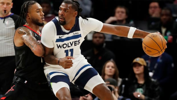 Feb 4, 2024; Minneapolis, Minnesota, USA; Minnesota Timberwolves center Naz Reid (11) drives to the basket against Houston Rockets guard Cam Whitmore (7) in the fourth quarter at Target Center.